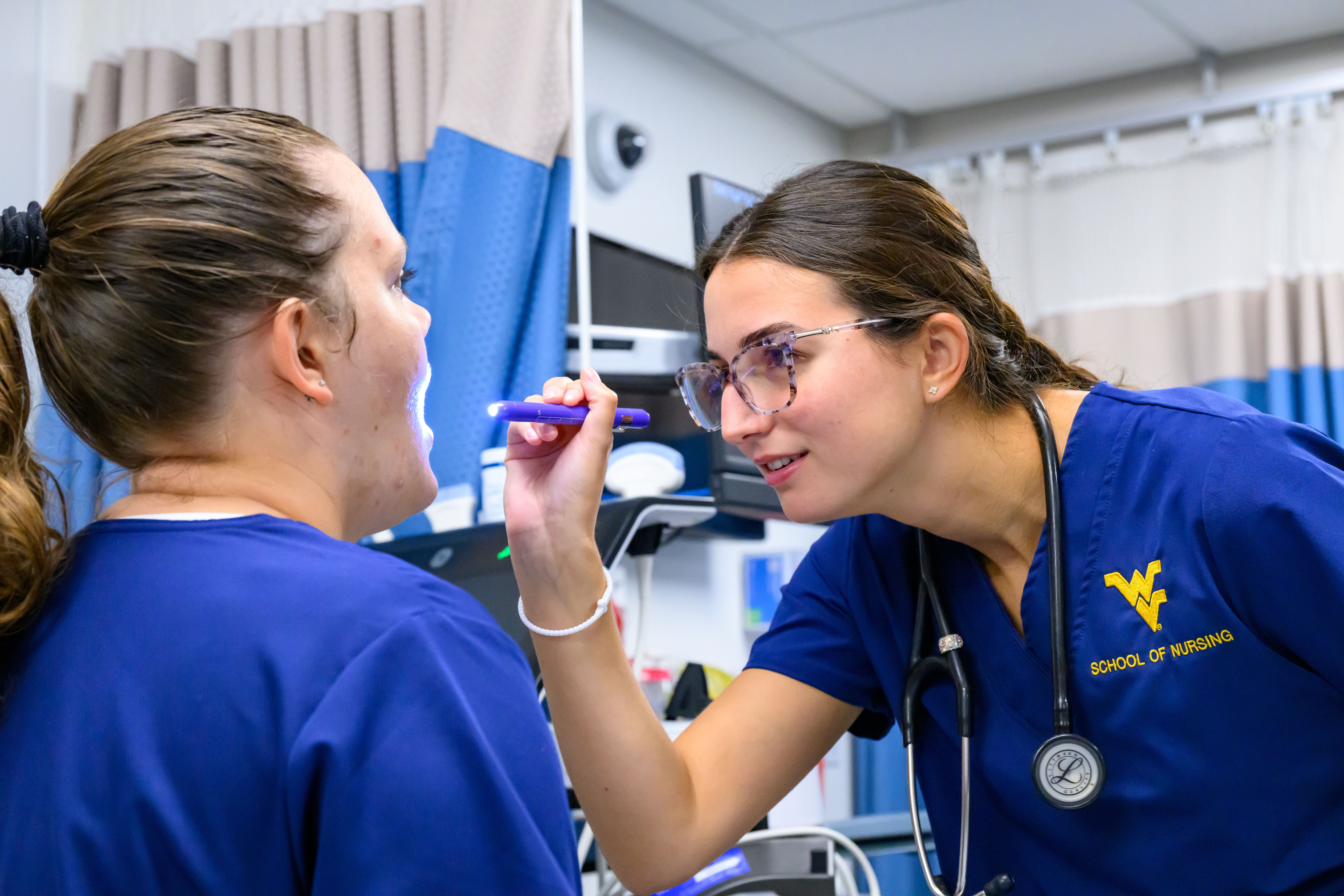 Nursing student poses for a photo at the commencement ceremony.